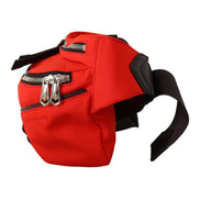 Red designer belt bag with silver zippers and black adjustable strap, luxury fashion accessory