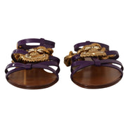 Purple strappy sandals with gold ornate embellishments and brown soles, luxury designer style
