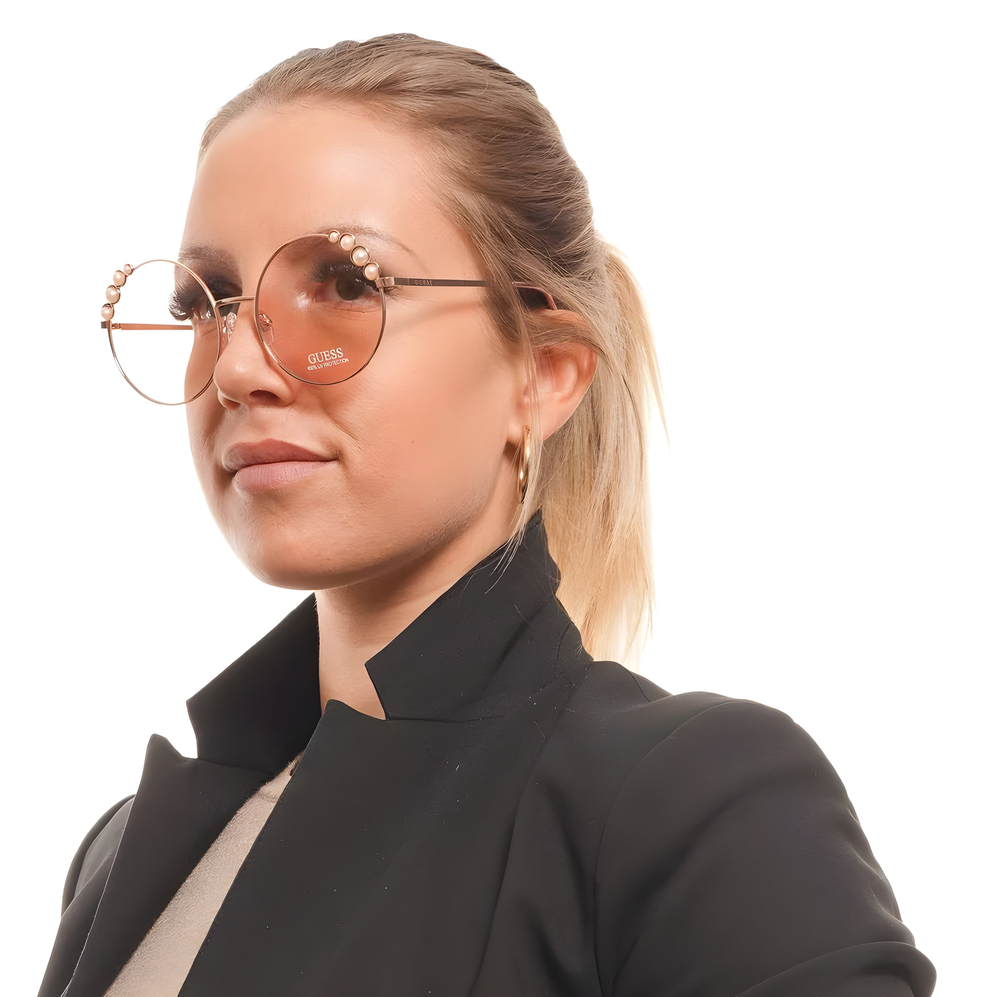 Woman wearing oversized round Guess sunglasses with pearl accents and a black blazer